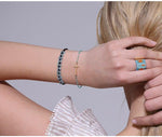 Pulseira com cruz pérolas azuis valor por defeito título
