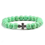 Pulseira com cruz pérolas de pedra verde claro