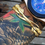 Pulseira rígida de aço dourado