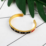 Pulseira rígida desportiva ouro e preto / 62 mm