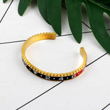 Pulseira rígida desportiva ouro e preto / 62 mm